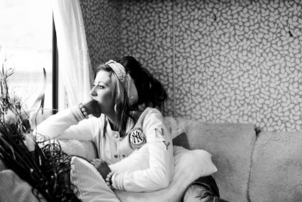 An Irish Traveller watches neighbouring children play from her trailer window. (Photo: Mackenzie Reiss)