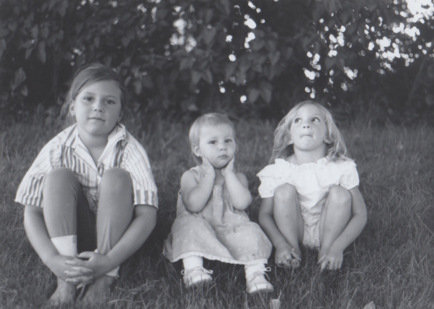  Sisters sitting in front of the lilac bushes. Left to right: Jessie, Emma, and Rachel. 