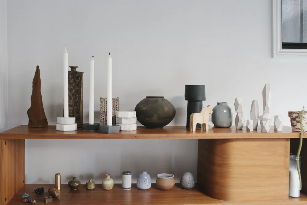 Stone Candle Holders stacked and assembled on a wood shelf