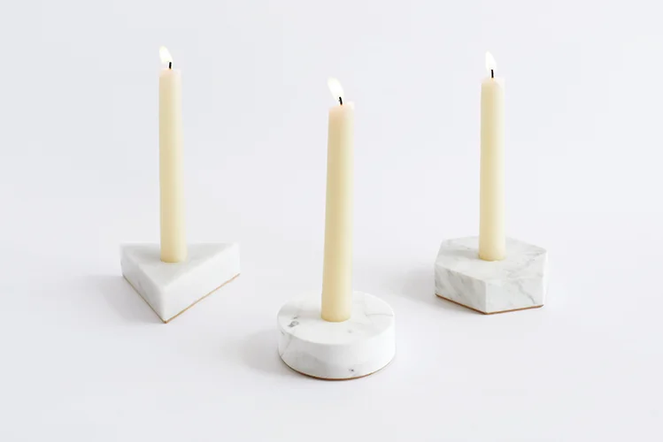 White Carrara Stone Candle Holders in round, triangle and hexagon shapes on white background.