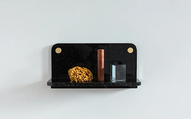 Black Marble Stone Shelf accessorized with bathroom products on white background