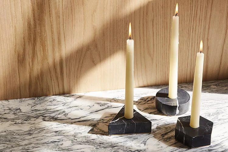 Black Marble Candle Holders in Circle, Triangle and Hexagon Shapes Sitting on Stone Countertop