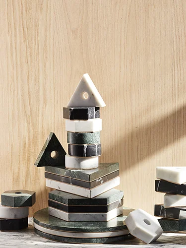 Stone Candle Holders and Trivets stacked high in a variety of stone options and shapes