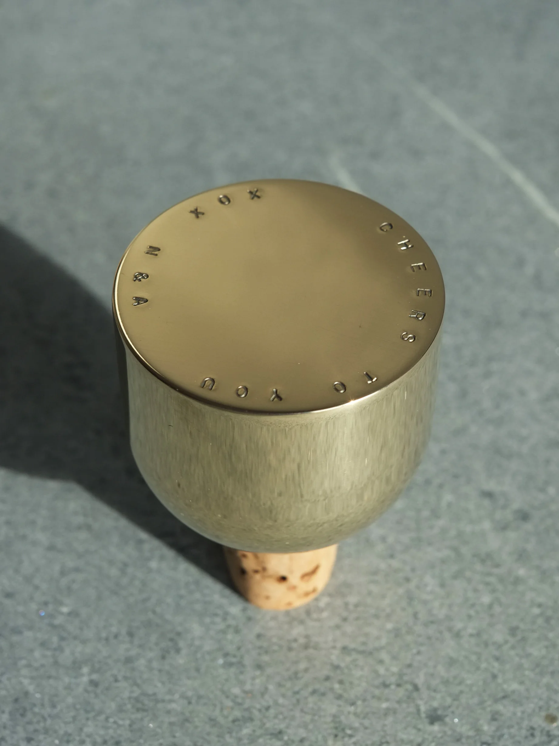 Detail view of custom stamped Mass Wine Stopper