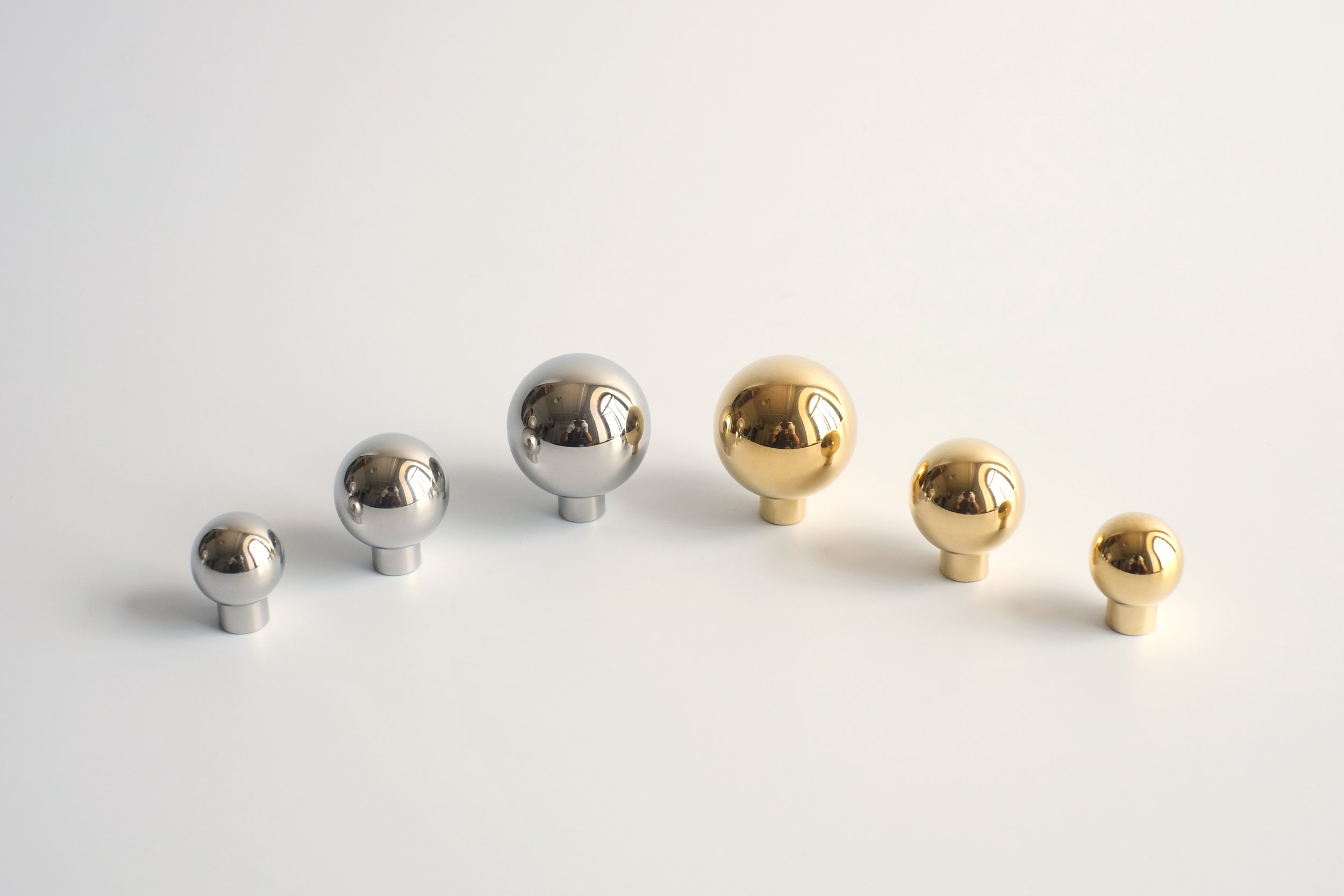 Full Collection of Polished Sphere Knobs in Both Brass and Stainless Steel shown in all sizes: Small, Medium, Large