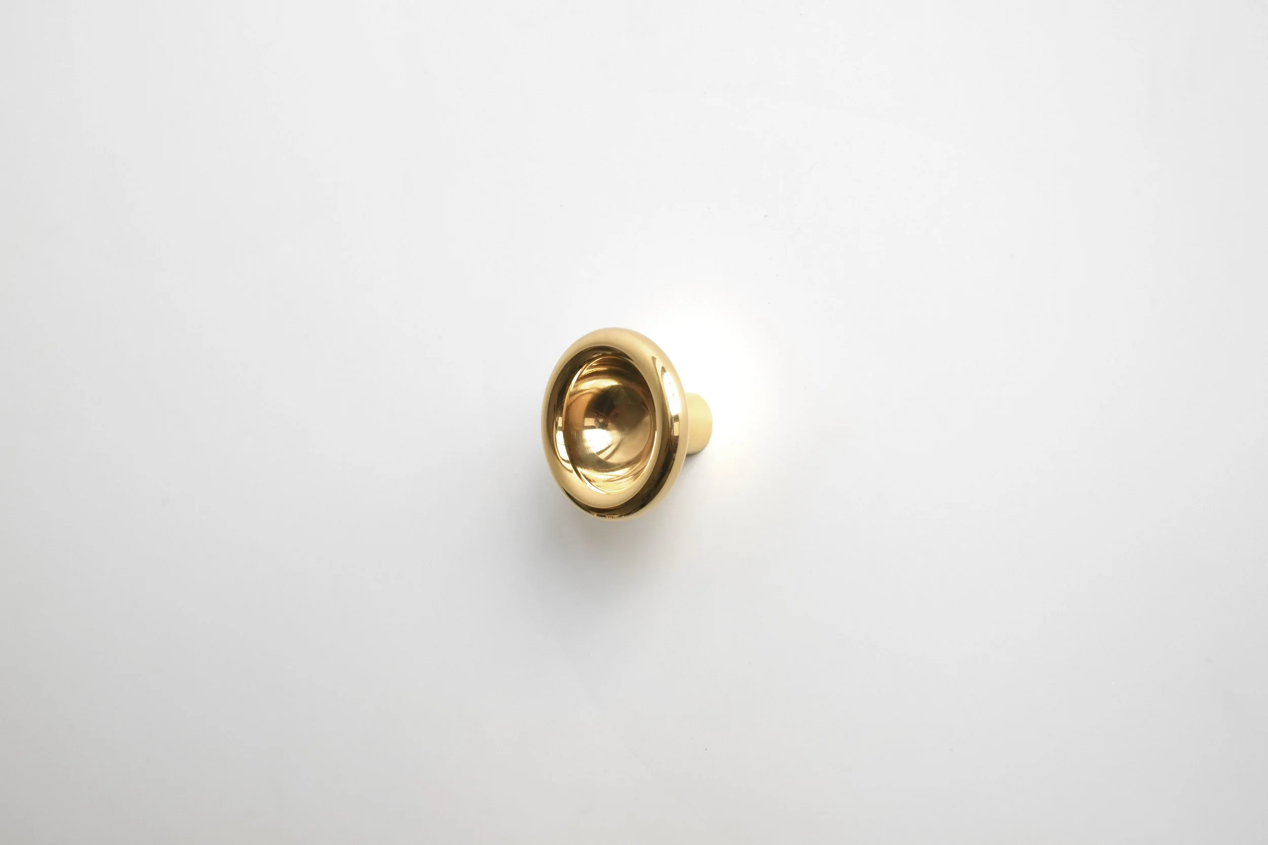 Profile View of Concave Knob in Polished Brass