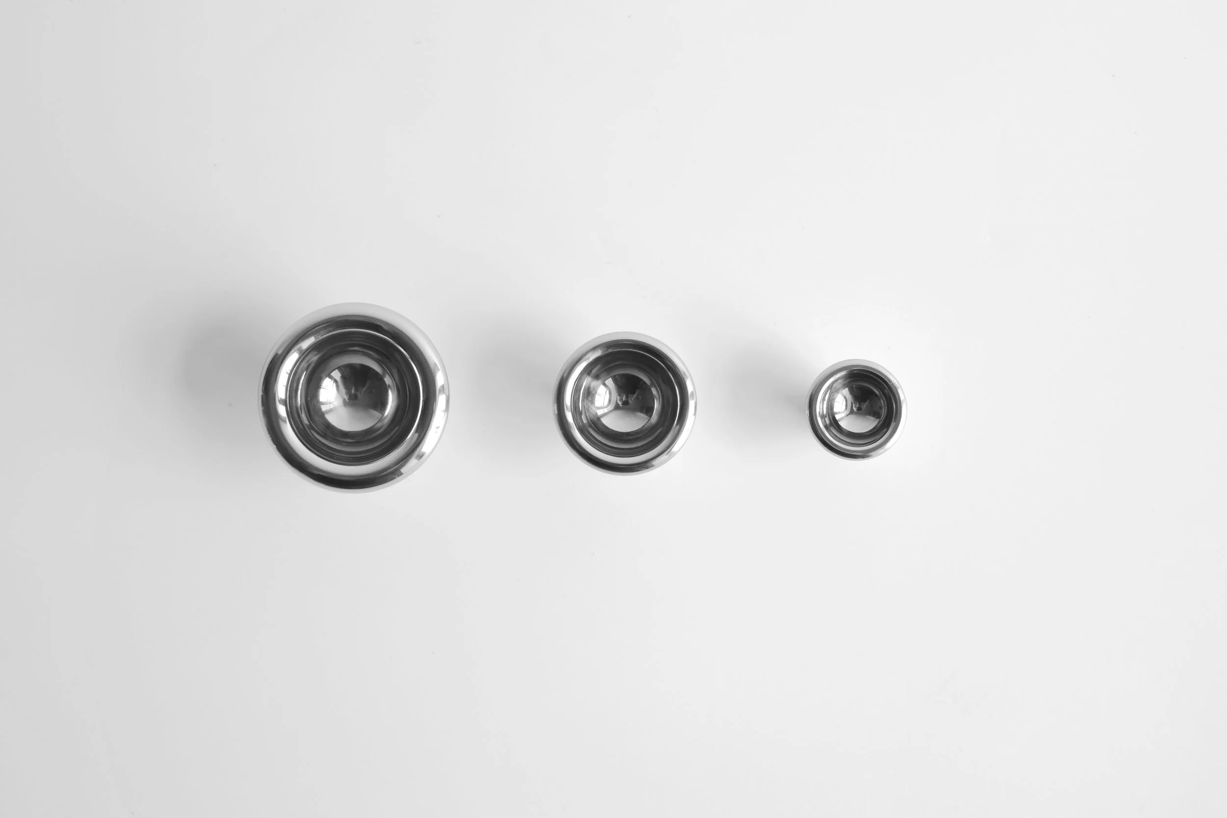 Concave Knobs in Polished Stainless Steel in Three Sizes: Large, Medium, Small