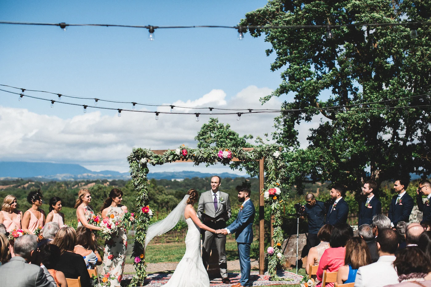 Lauren and Ali exchanging vows amid the beautiful backdrop at Arista Winery. Photo by Studio Castillero .