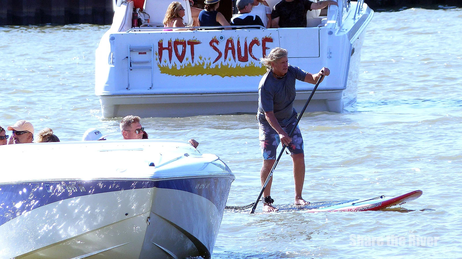 A StandUp Paddleboarder Dances on the Cuyahoga River with the Cleveland Air Show Armada 