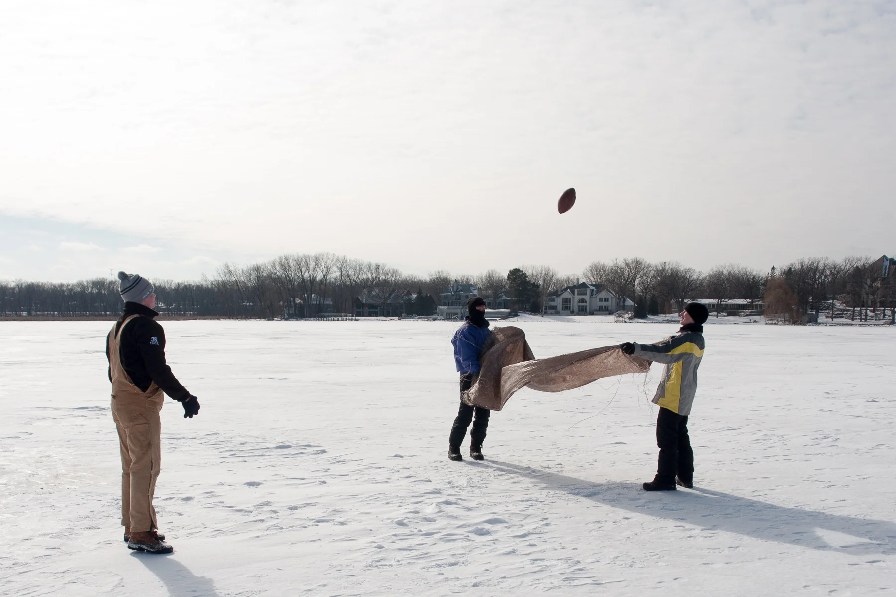 Teamwork exercises at Tikchik Lake Territory involved catching and tossing a football using a tarp.