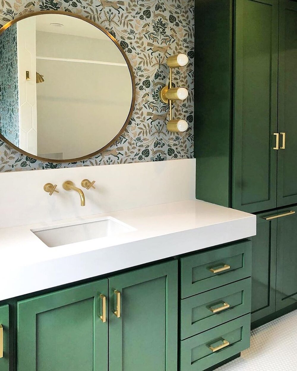 bathroom with green cabinetry and wallpaper .jpg