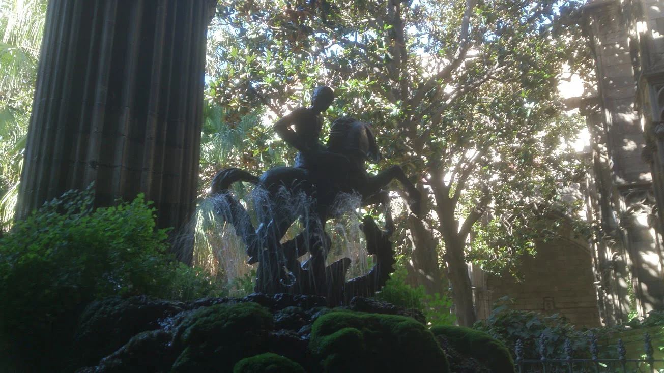 St George, patron of Barcelona, slaying the dragon, on top of a beautiful fountain in Barcelona Cathedral cloister.