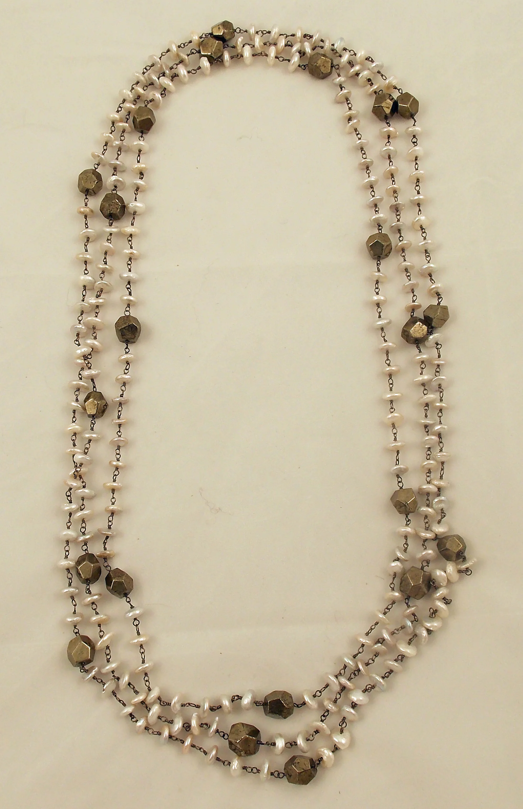 Pearl and pyrite strands