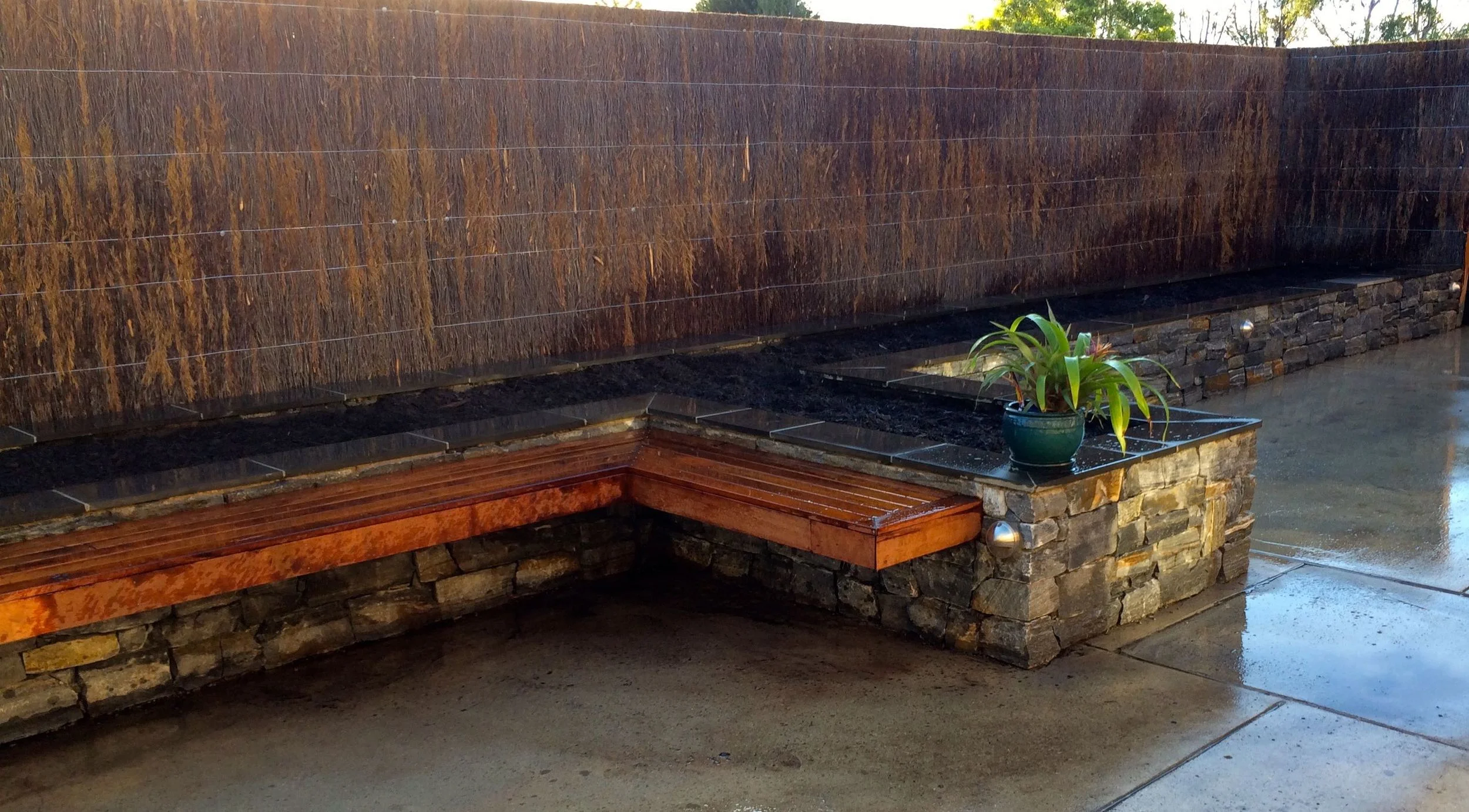 Jindera Dry Stone Wall . Floating Merbau Bench. Brushwood Fence. Stainless Steel, Hooded Downlights. Bluestone Capping.