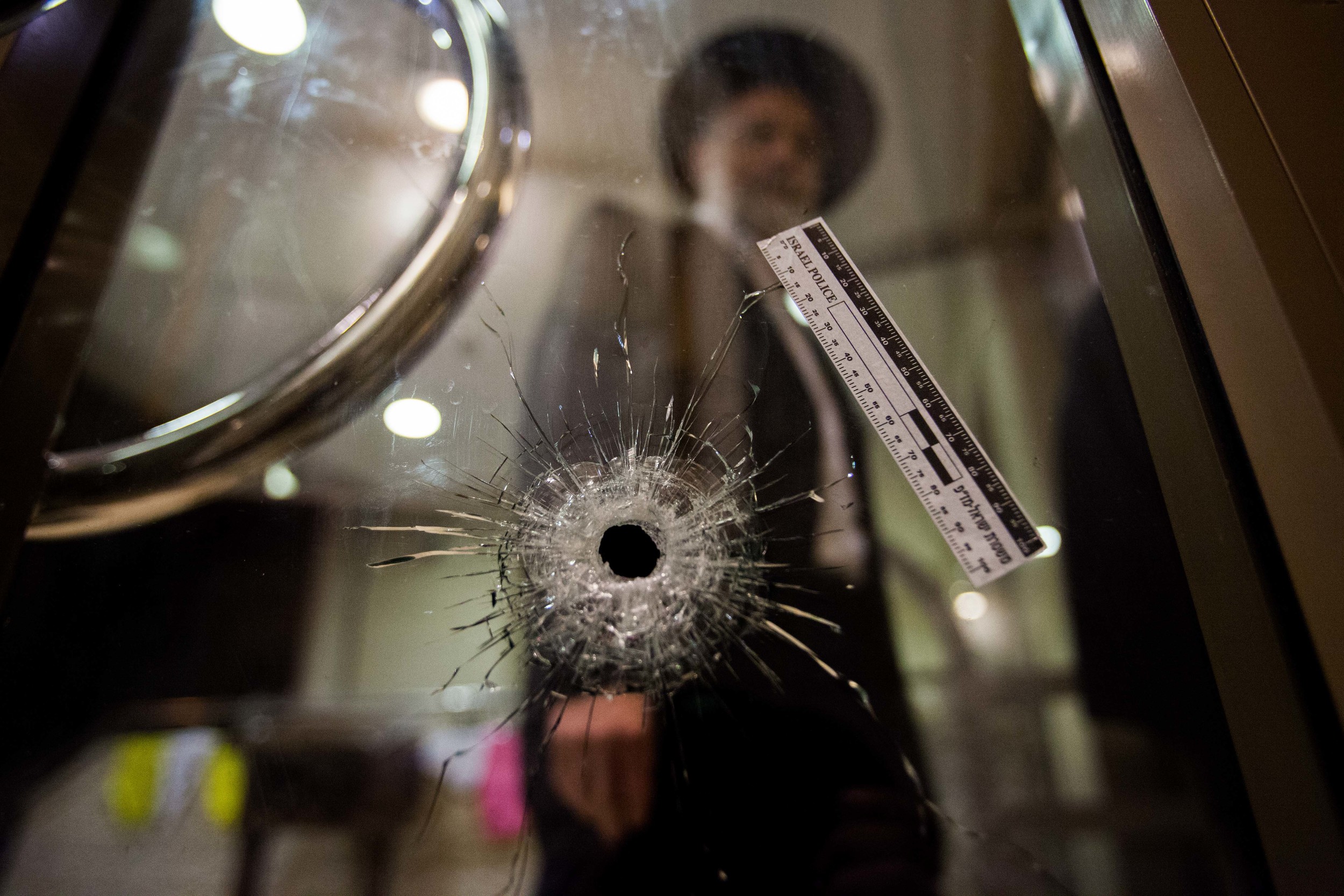  A man walks next to a bullet hole inside a synagogue where two terrorists Attack the Kehilat Yaakov synagogue in the Jewish orthodox neighborhood of Har Nof&nbsp;Jerusalem on&nbsp; November 18, 2014.     