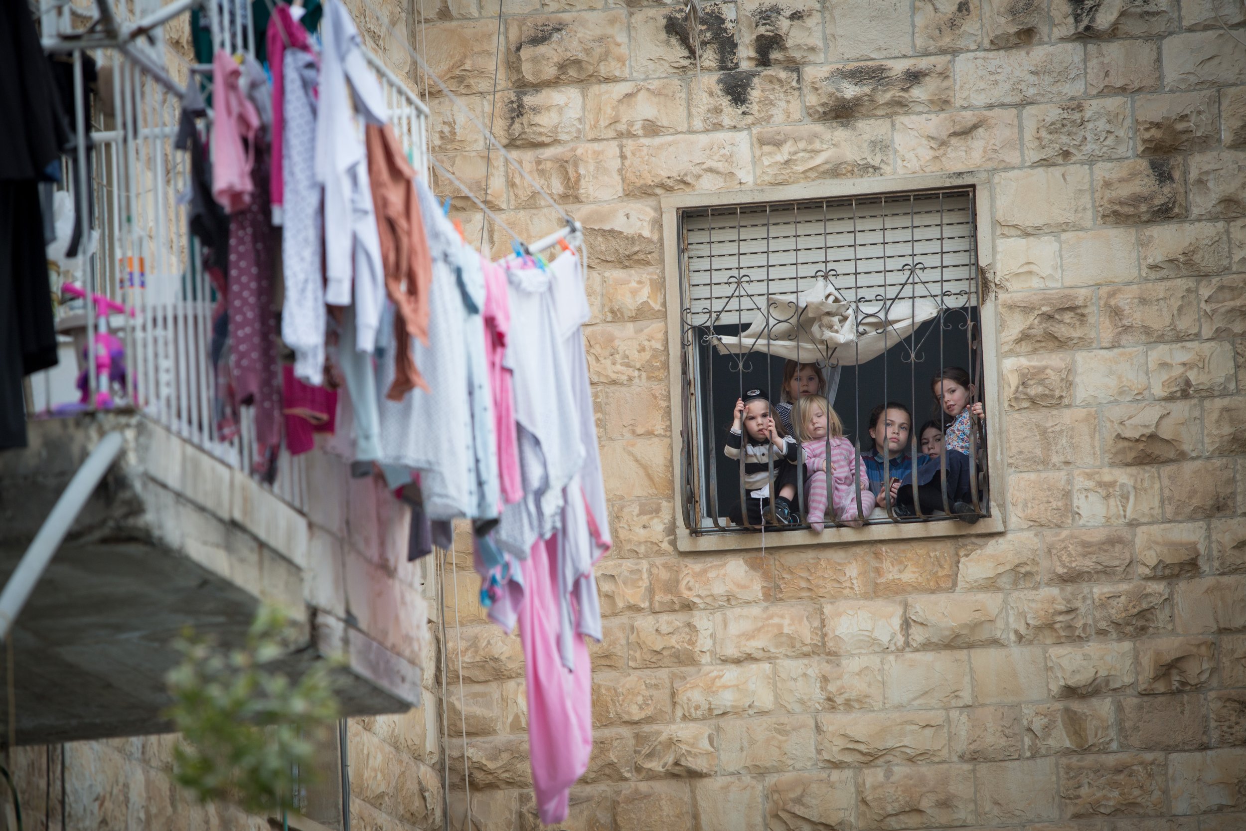  An Ultra orthodox Family looking out the window at Makor Baruch neighborhood in Jerusalem on October 18, 2018. 
