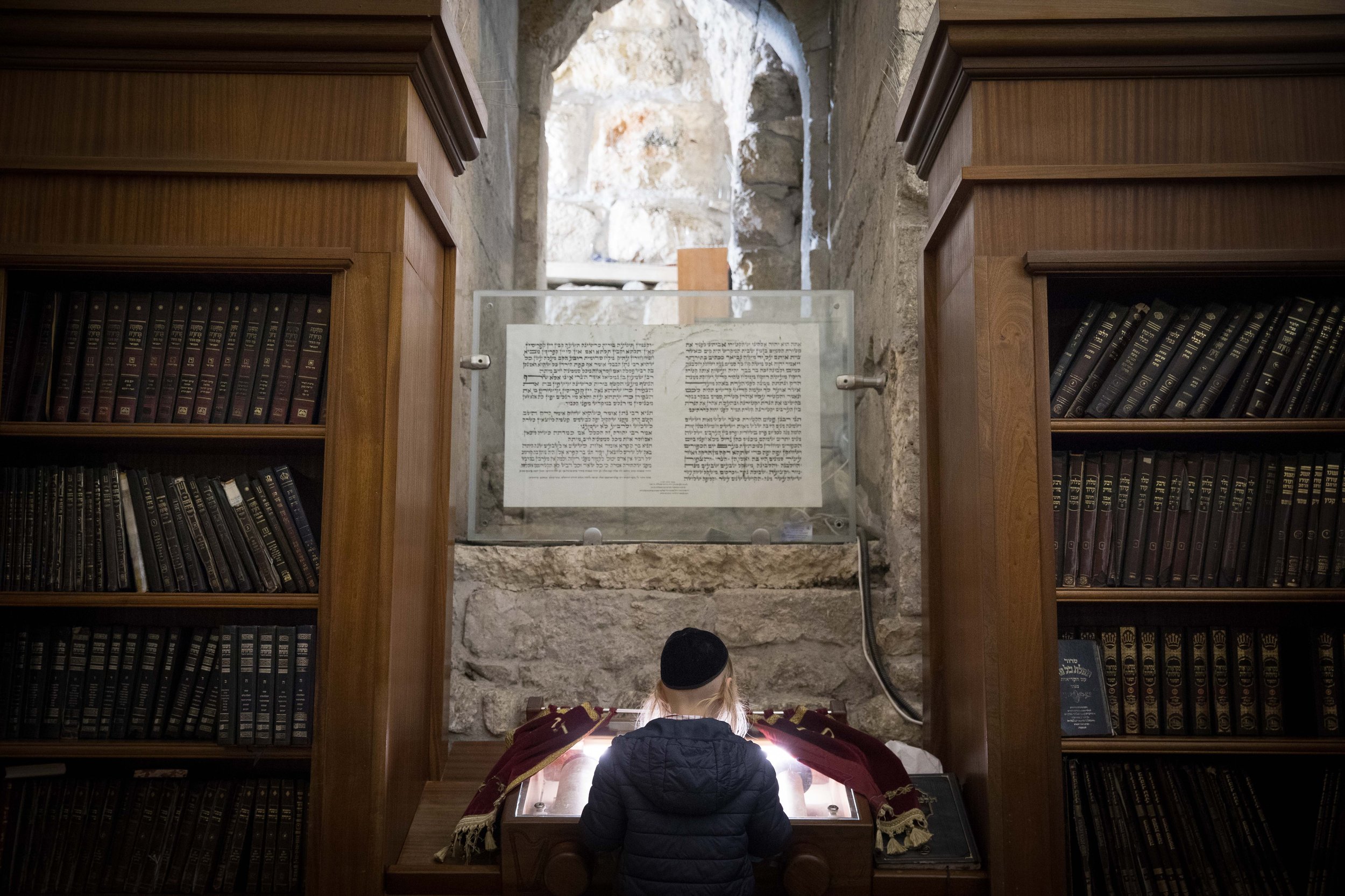  A young boy reading a Torah scrollat the Westren Wall, Judaism's holiest prayer site in the Old City of Jerusalem on April 18, 2019. 