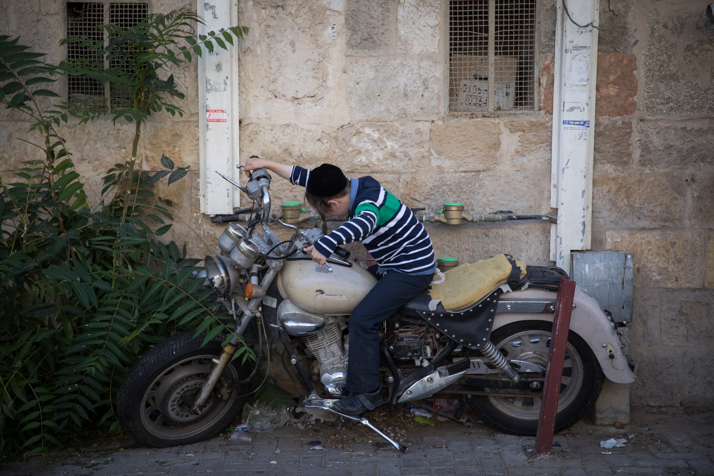  Ultra Orthodox Jews kids sit on a motorcycle in the ultra orthodox neighborhood of Meah Shearim, in Jerusalem. October 6, 2019. 