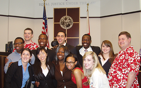 Miami A posing after a successful weekend in the courtroom. Back row, left to right: Zowoi Malakpa, coach Neal Schuett, Brandon Patterson, Alex Block, Brad Ouambo, Allie Pickerell and coach Dan Haughey; front row: Lauren Yates, Claire Meikle, Deborah O'Neal, Jazmine Kee and Katie O'Keeffe (photo by Susan Meikle).