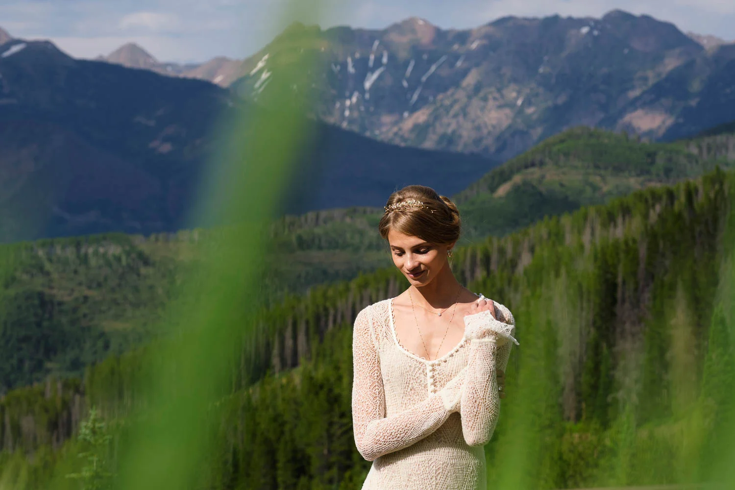 Anna Selzneva poses against mountain backdrop in Vail. Fashion model Anna Selezneva's wedding in Vail Colorado. Wedding ceremony at the Vail Chapel. Wedding reception at The 10th on Vail Ski Resort.