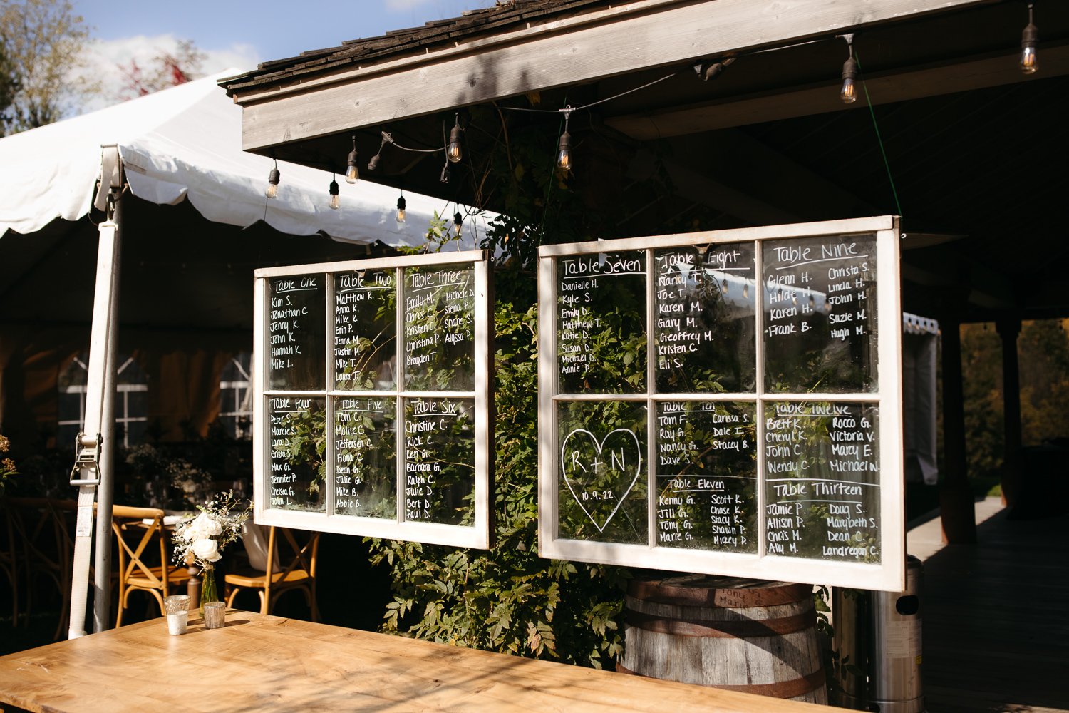 Wedding seating chart displayed on antique window panes at Windrift Hall in the Catskills