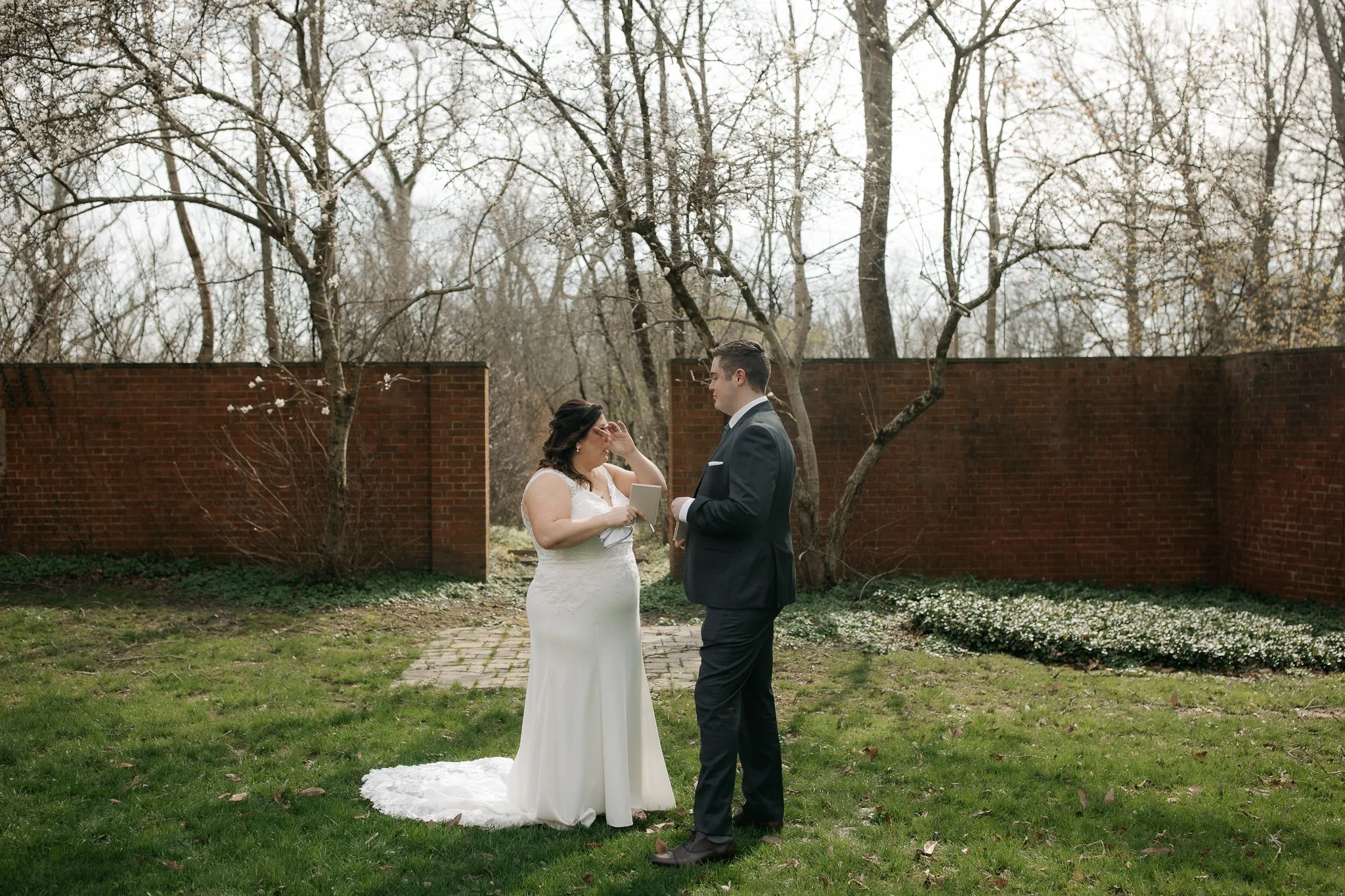 Couple reading vows together in quiet garden setting during wedding
