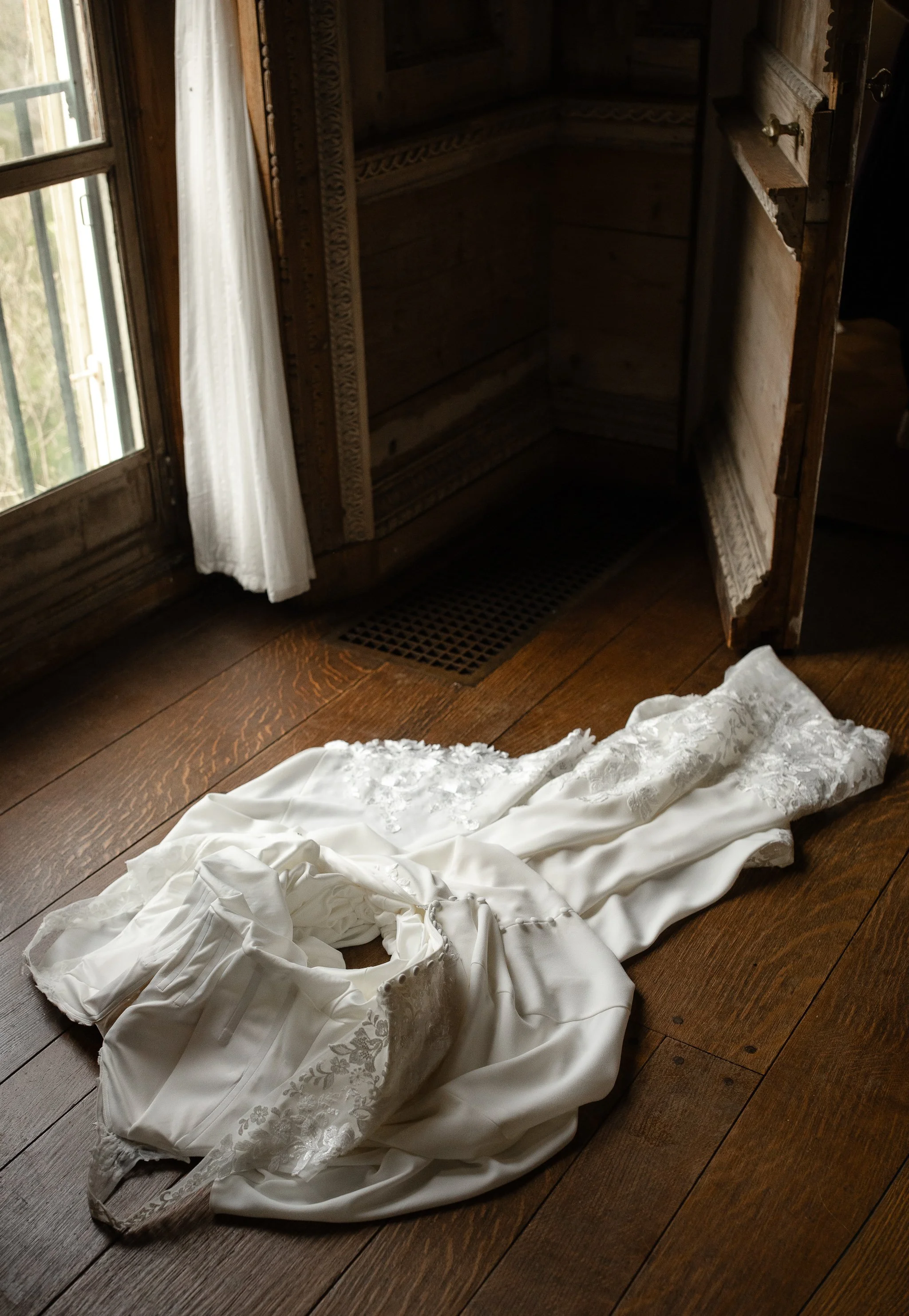 Wedding dress laid near window with natural light in Peterloon Estate bridal suite