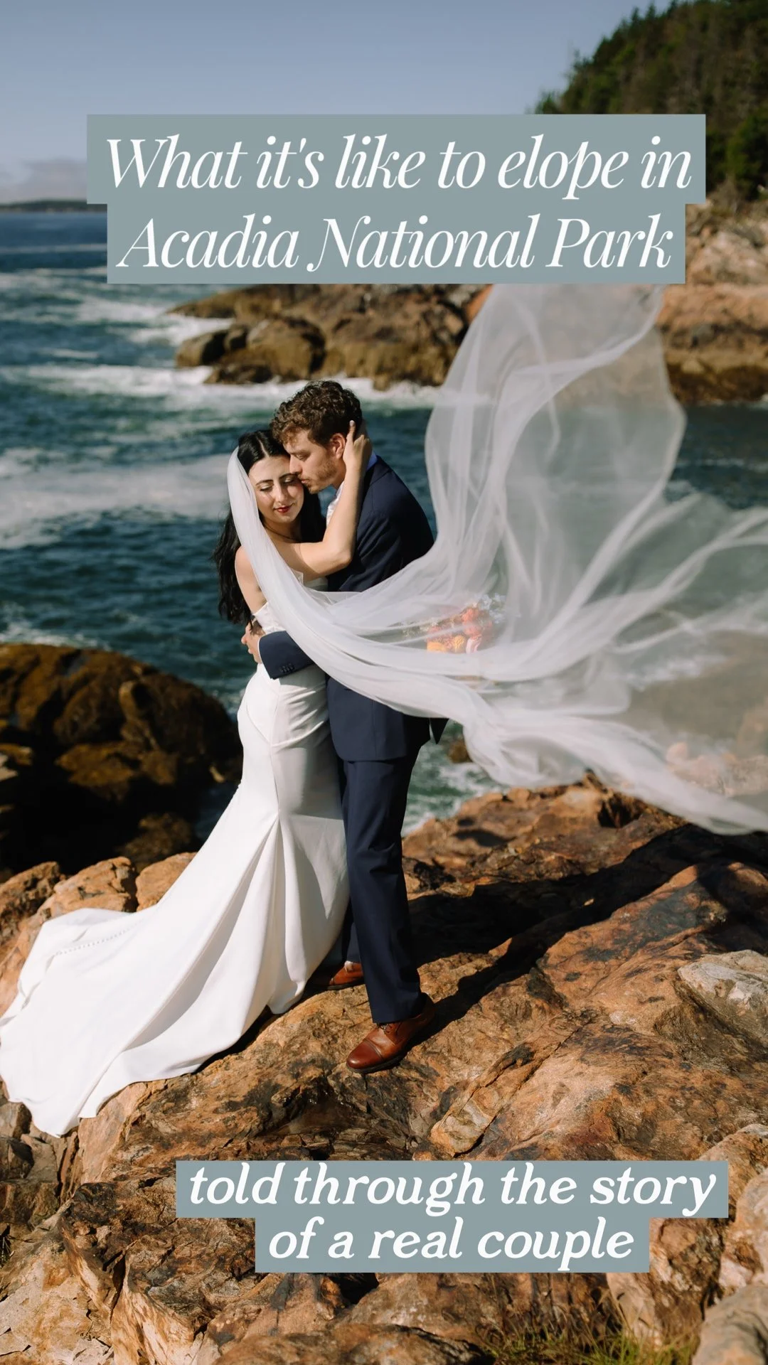 Bride and groom embracing on a rocky Acadia National Park cliff as the bride’s veil blows dramatically in the ocean wind.