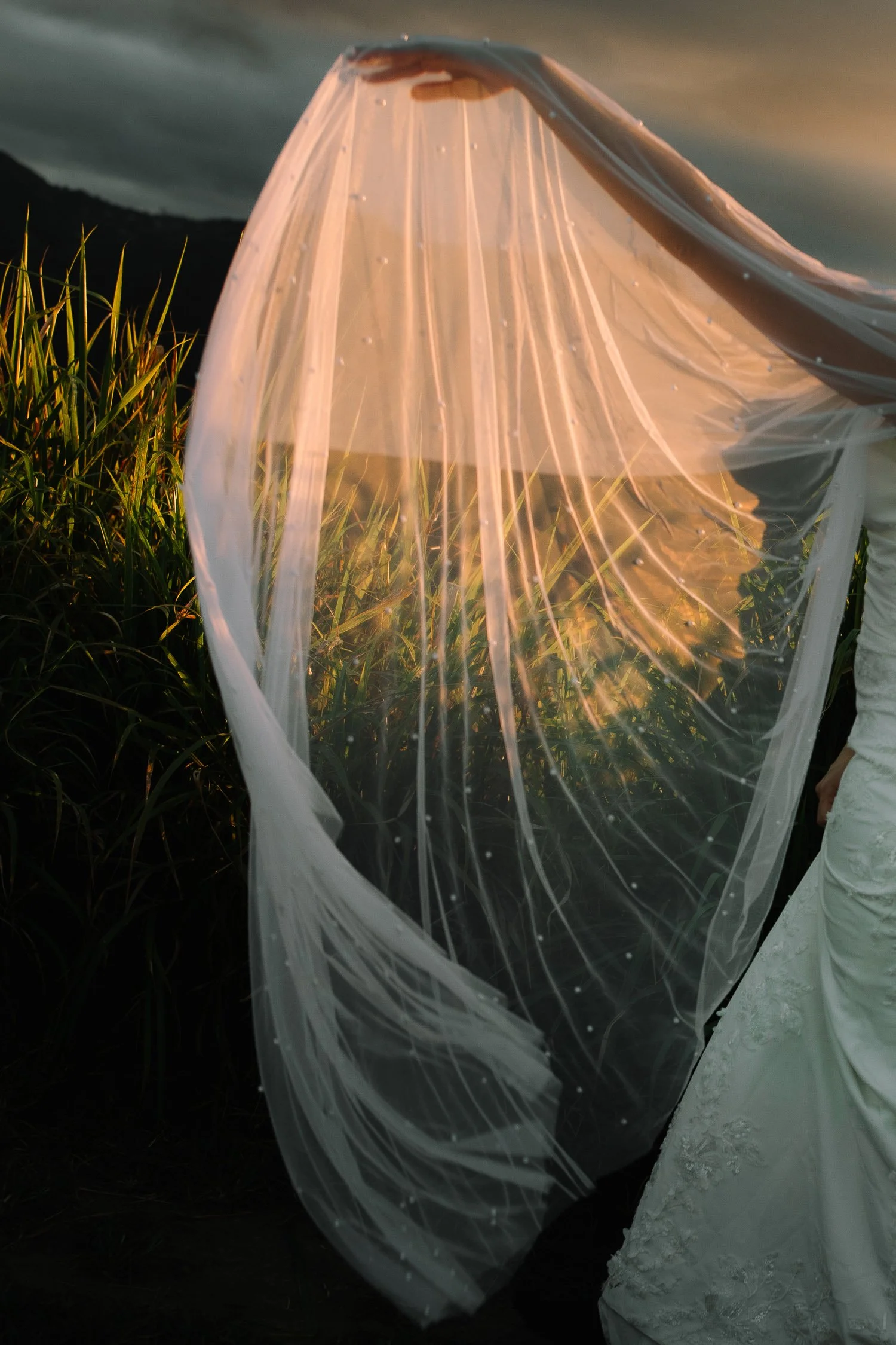 Wedding veil lifted by the wind against the sky during a mountain elopement at Cerro Mime