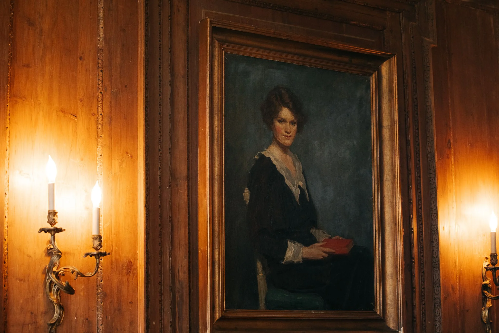 Antique oil painting and candle sconces inside Peterloon Estate showcasing historic interior details