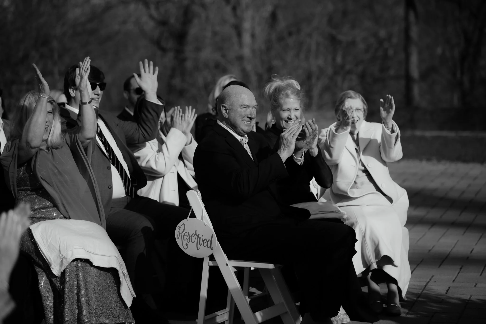 Guests cheering and clapping during wedding ceremony