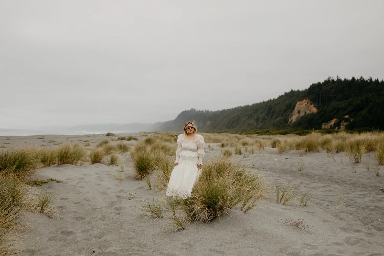 Bride walking through coastal sand dunes during a Northern California elopement