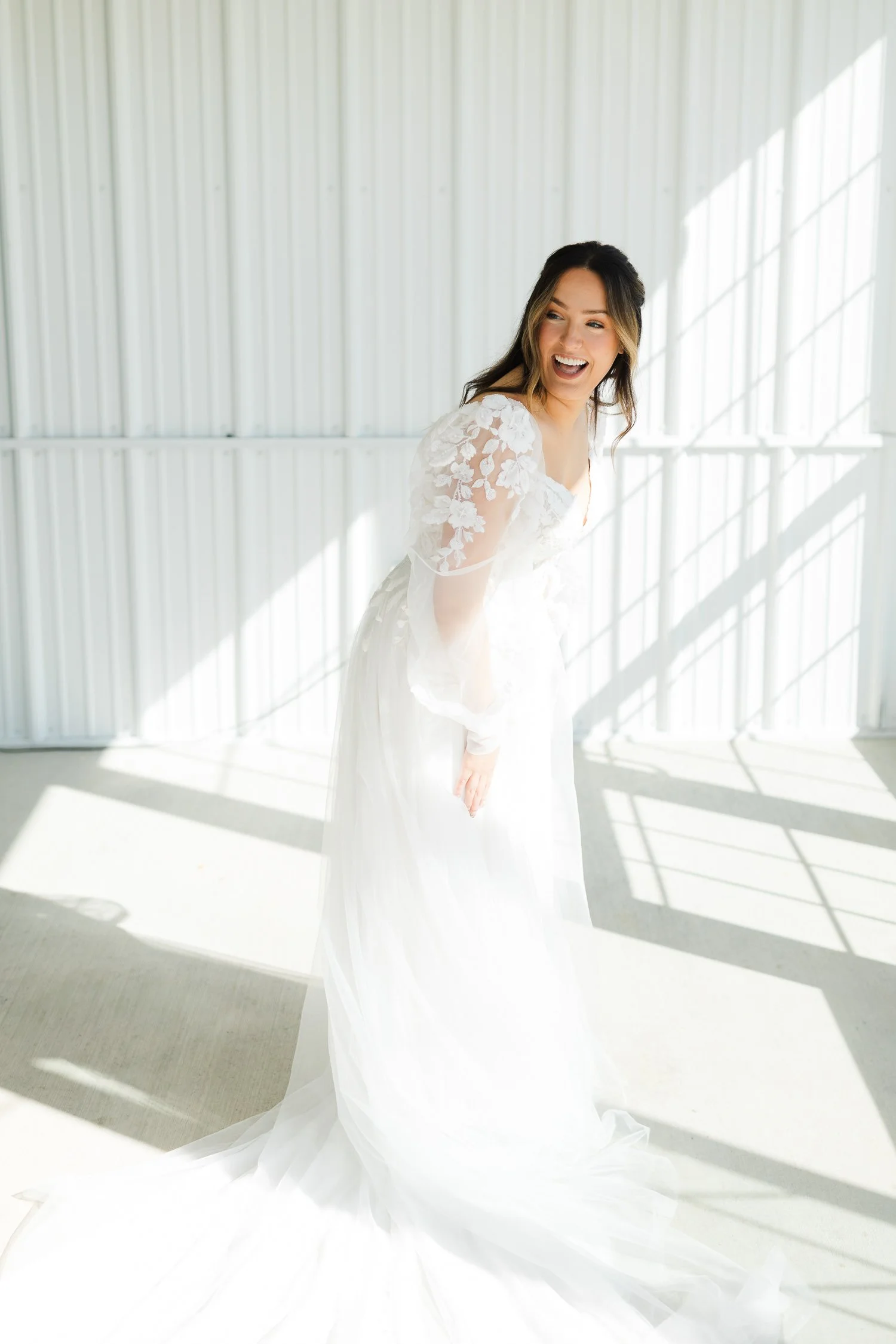 Bride laughing during getting ready portraits at Ivory Meadows in Yellow Springs, Ohio, photographed in bright natural light.