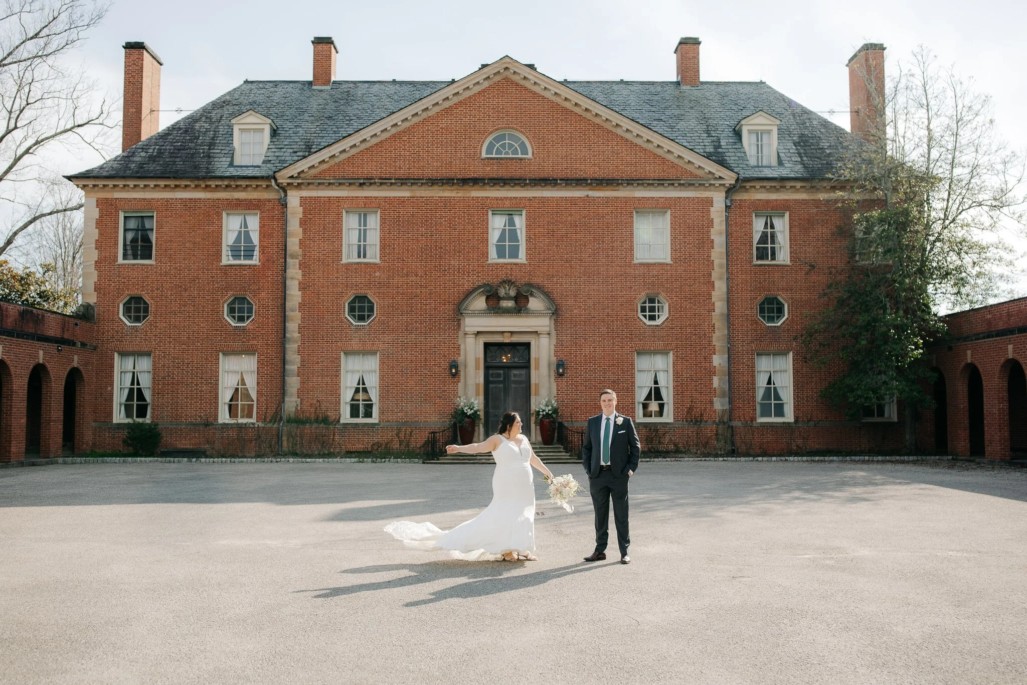 Bride and groom standing in front of Peterloon Estate in Cincinnati, Ohio during an intimate spring wedding