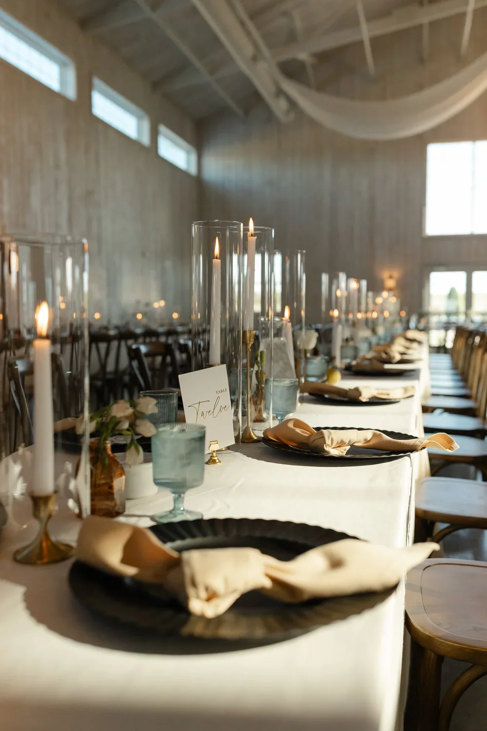 Long wedding reception table with candles and place settings at a Dayton, Ohio wedding
