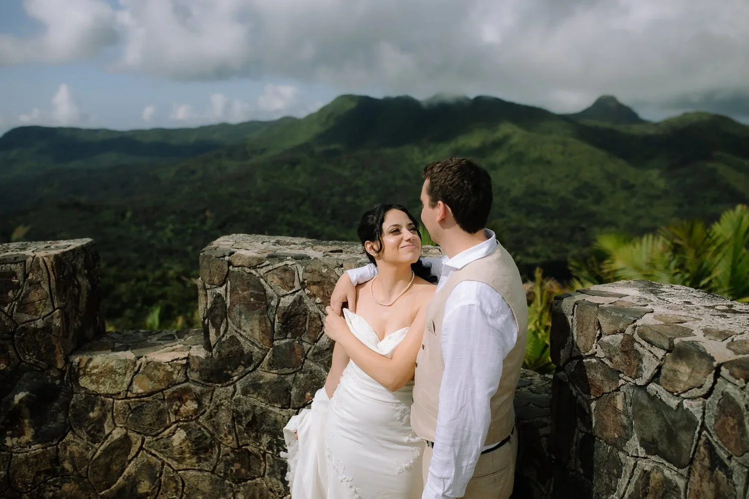 Eloping couple embracing near Mount Britton Tower in El Yunque National Forest