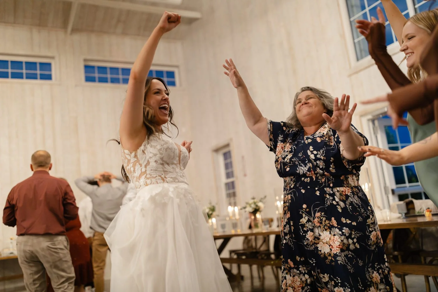 Bride dancing joyfully with a family member during her Ivory Meadows wedding reception in Dayton Ohio