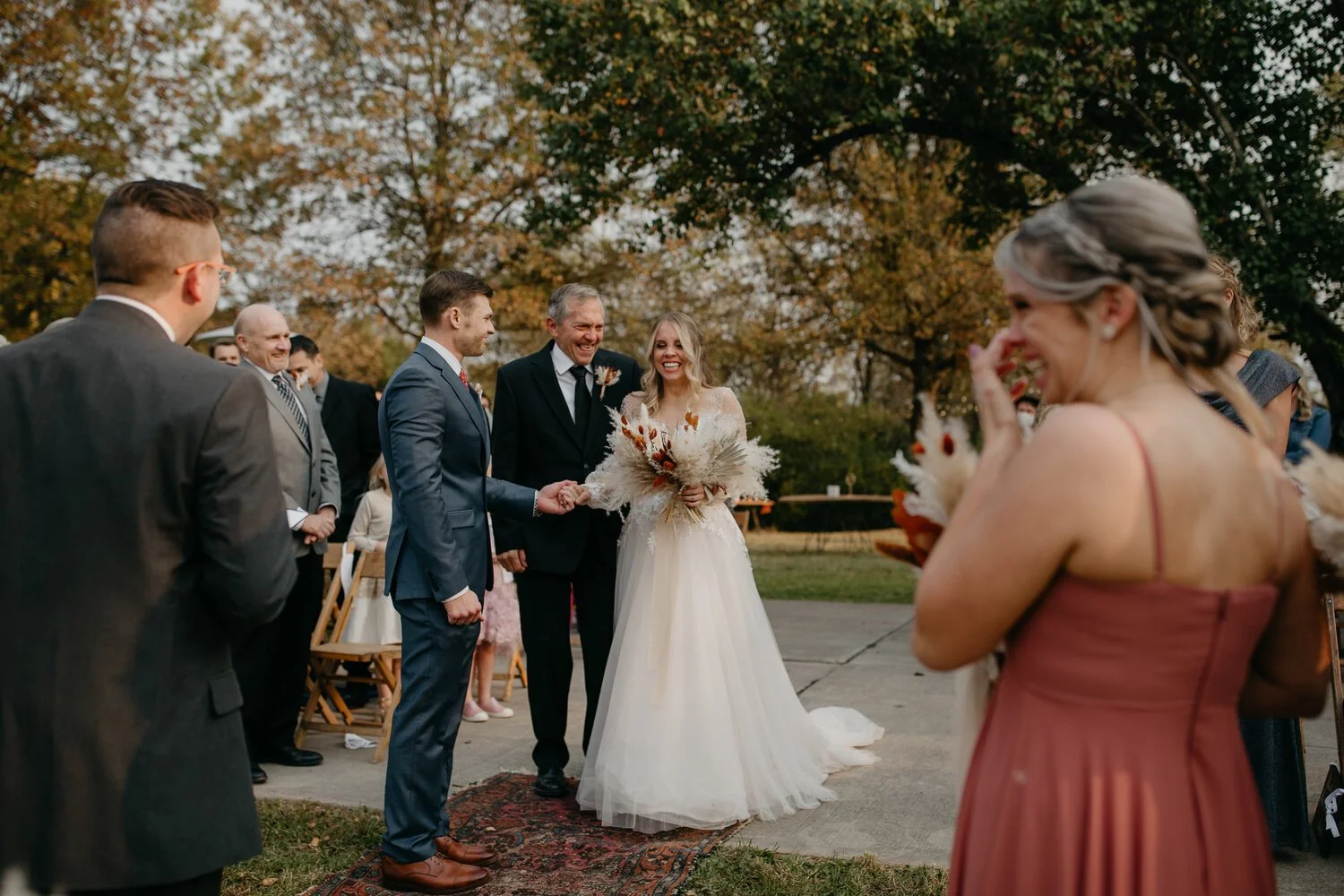 Couple exchanging vows during a backyard fall wedding in Cincinnati, Ohio