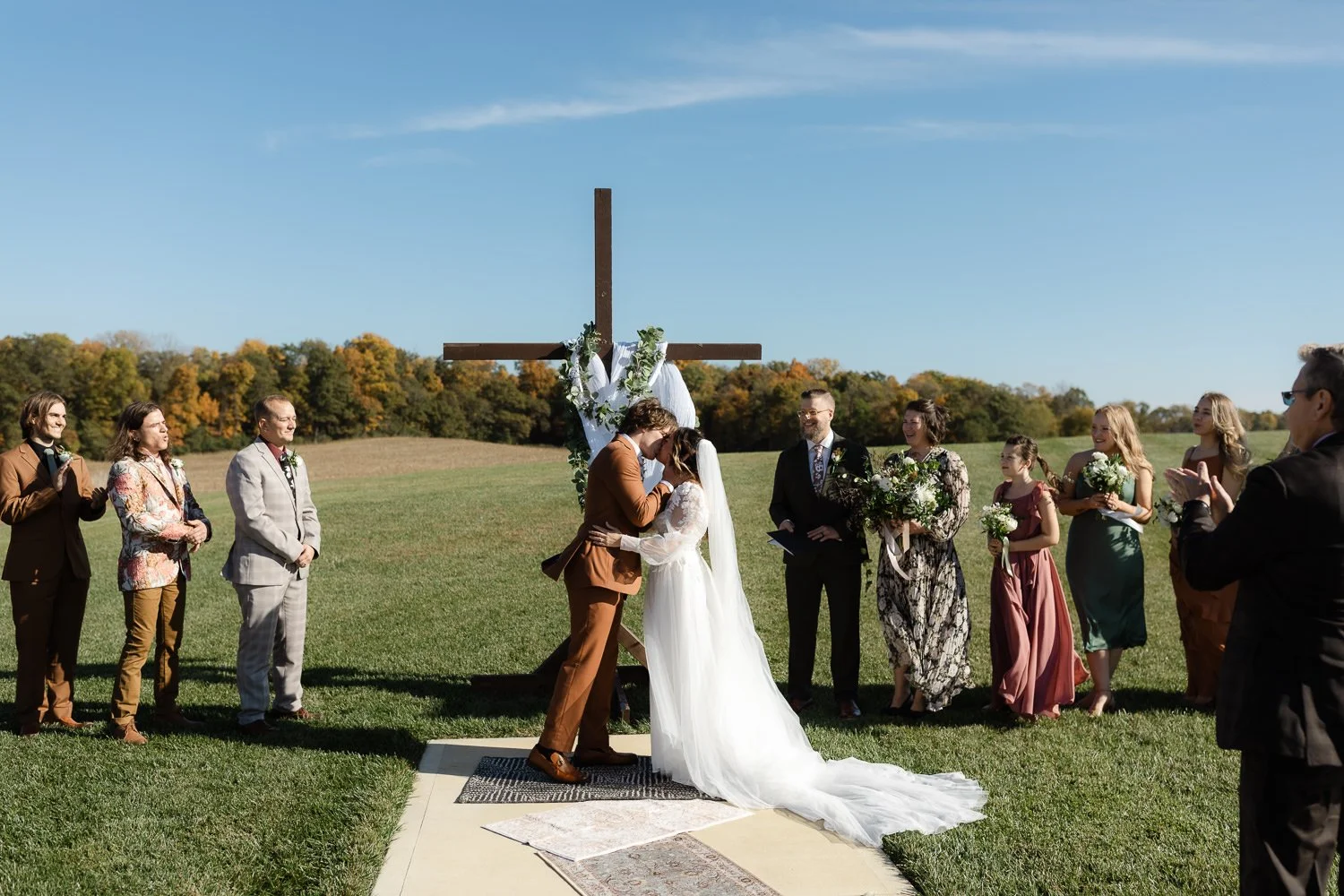 Bride and groom sharing their first kiss at an outdoor Ivory Meadows wedding in Dayton, Ohio
