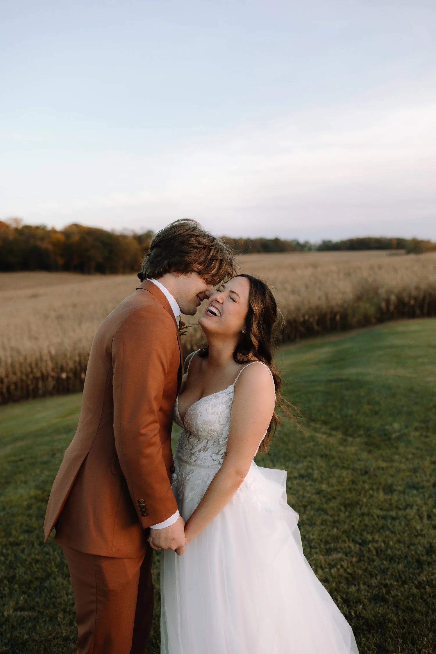 Romantic evening portraits of a bride and groom laughing together at Ivory Meadows wedding venue in Dayton, Ohio.