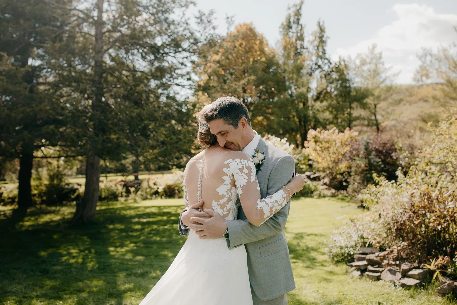 Bride and groom embracing during wedding portraits on the grounds of Windrift Hall in the Hudson Valley