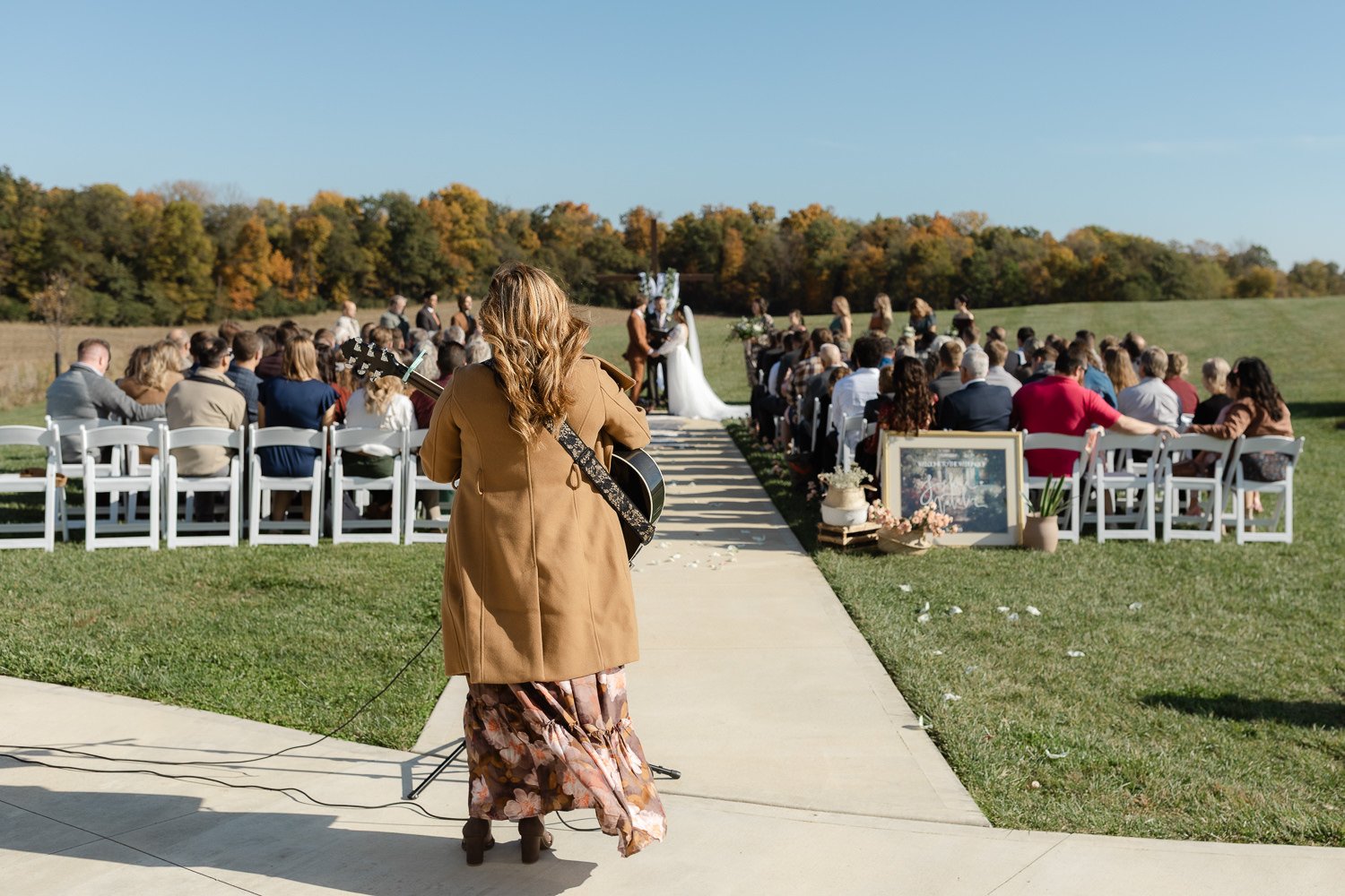 Wide view of an outdoor wedding ceremony with live music at Ivory Meadows in Yellow Springs, Ohio.