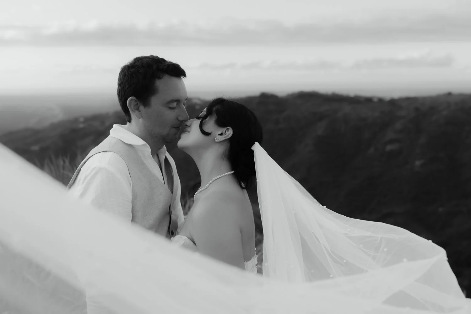 Bride and groom sharing an intimate moment with flowing veil during an elopement session near El Yunque in Puerto Rico