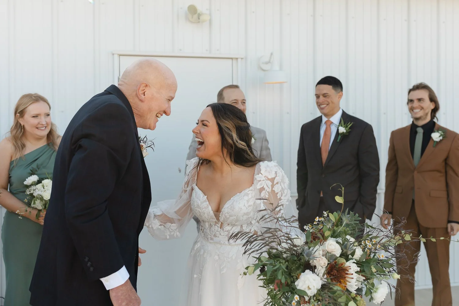 Bride laughing with father immediately after the ceremony at Ivory Meadows wedding venue in Dayton, Ohio.