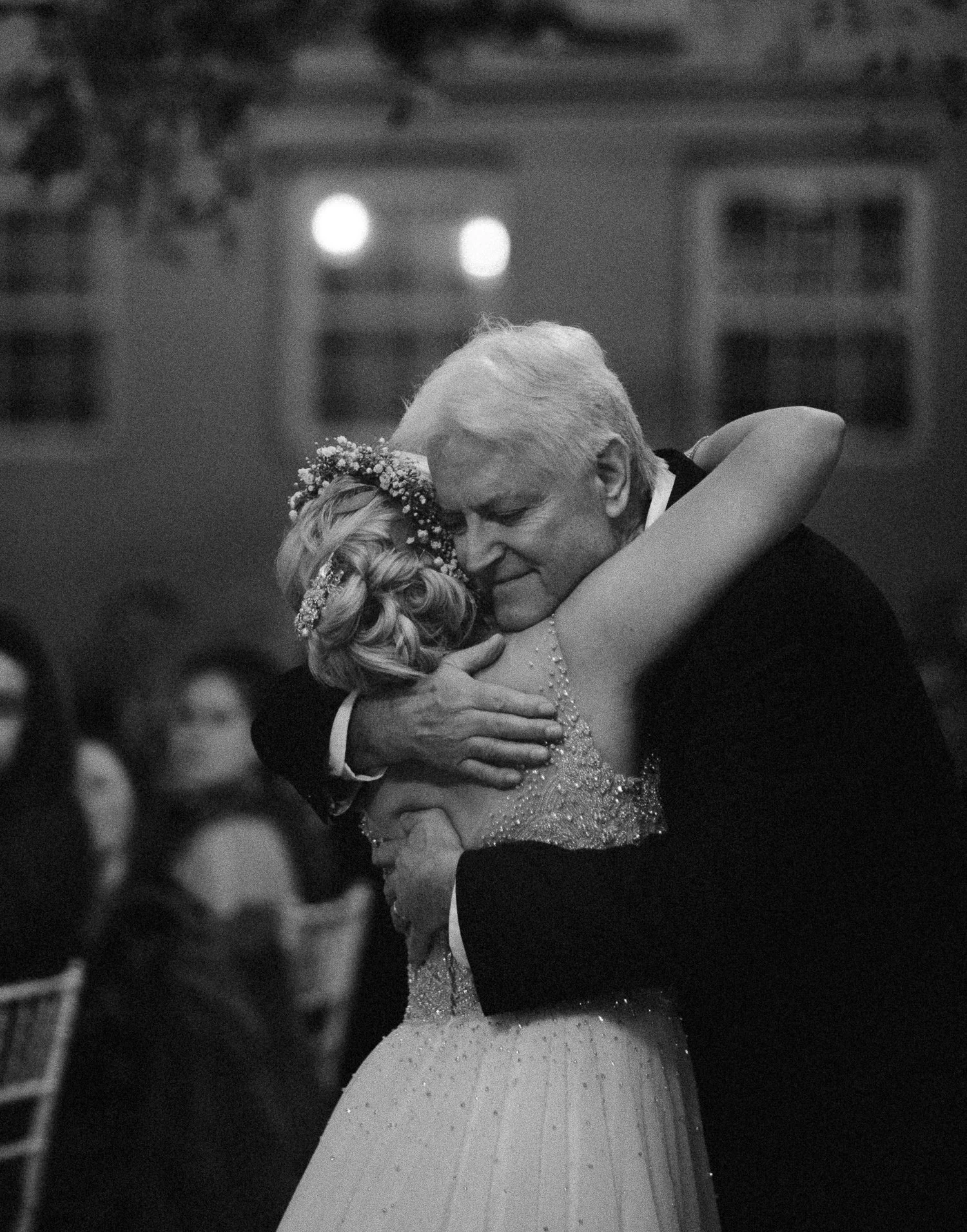 Emotional moment of a father hugging his daughter during the wedding reception