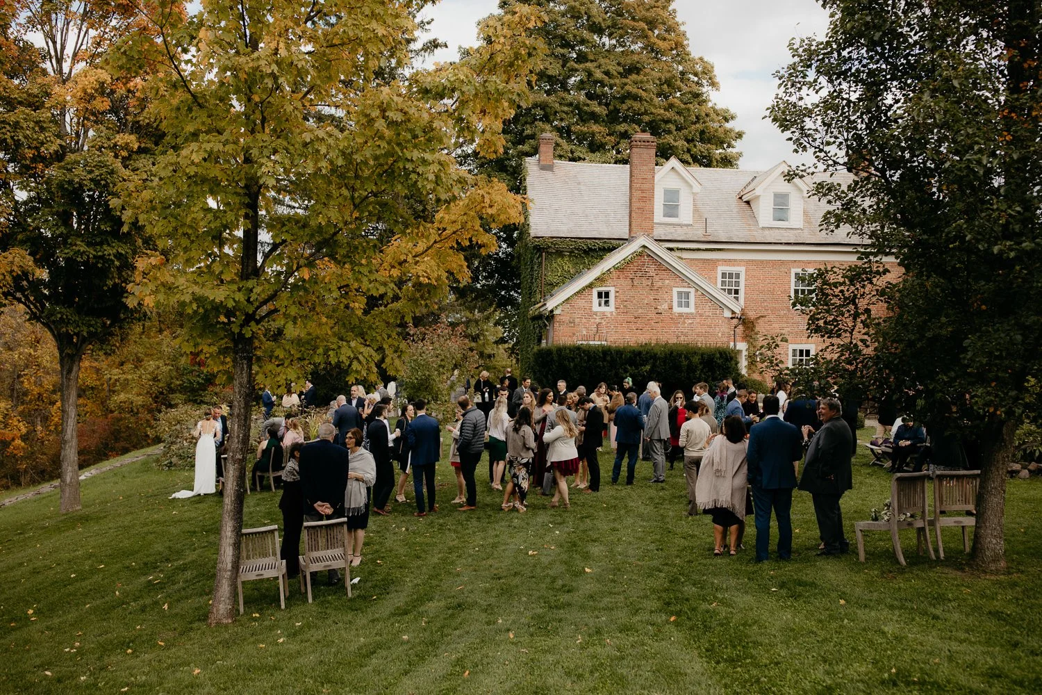Wedding guests gathering on the lawn outside Windrift Hall during cocktail hour