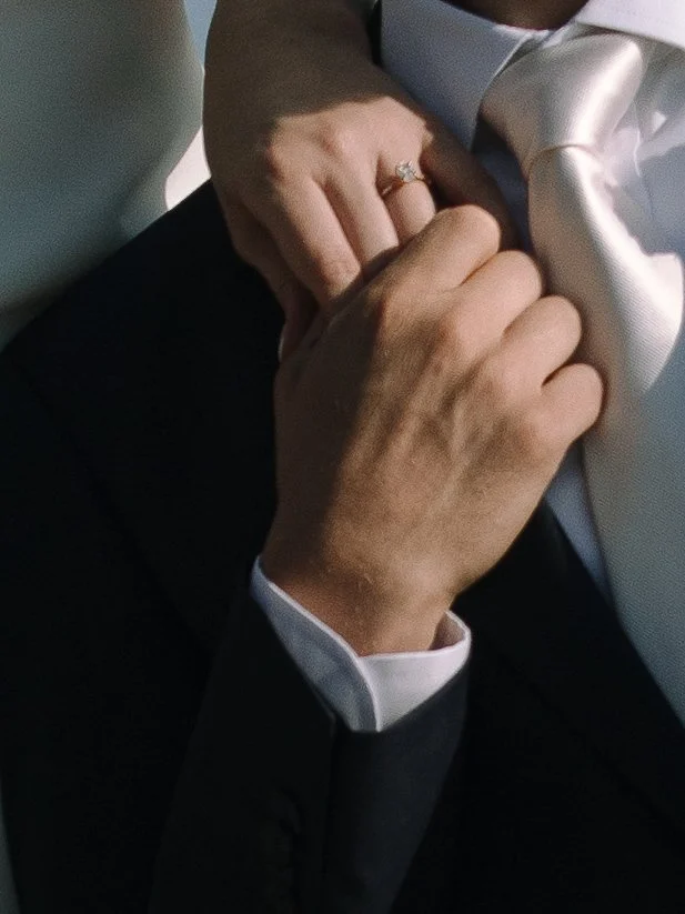 Close-up of wedding rings and hands during an Acadia National Park elopement on the Maine coast