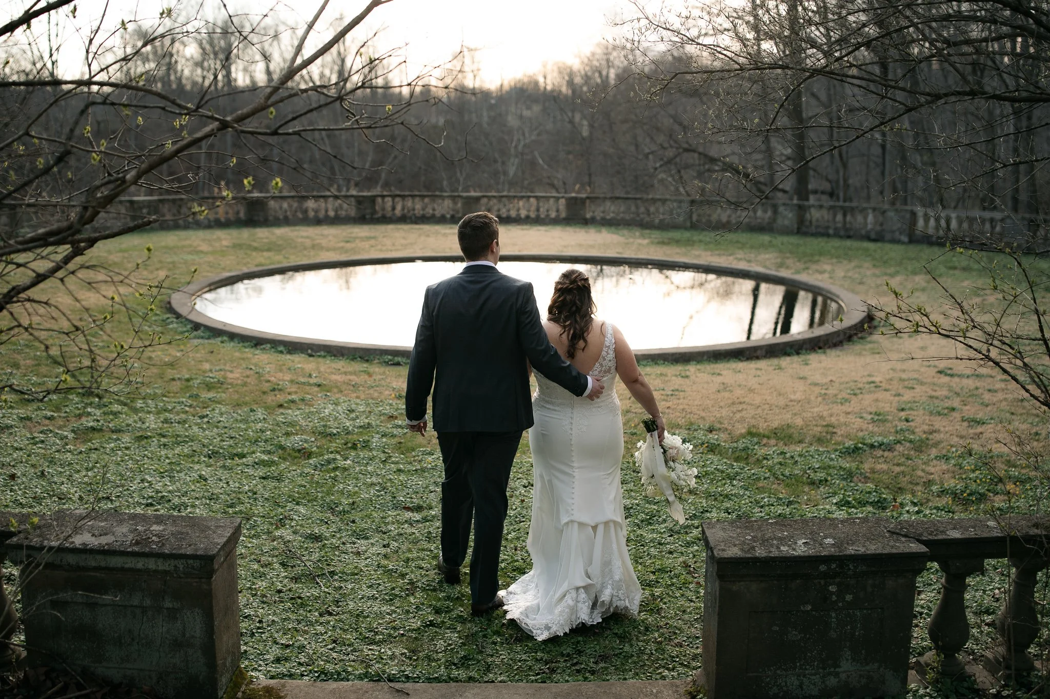 Couple walking beside reflecting pool at Peterloon Estate