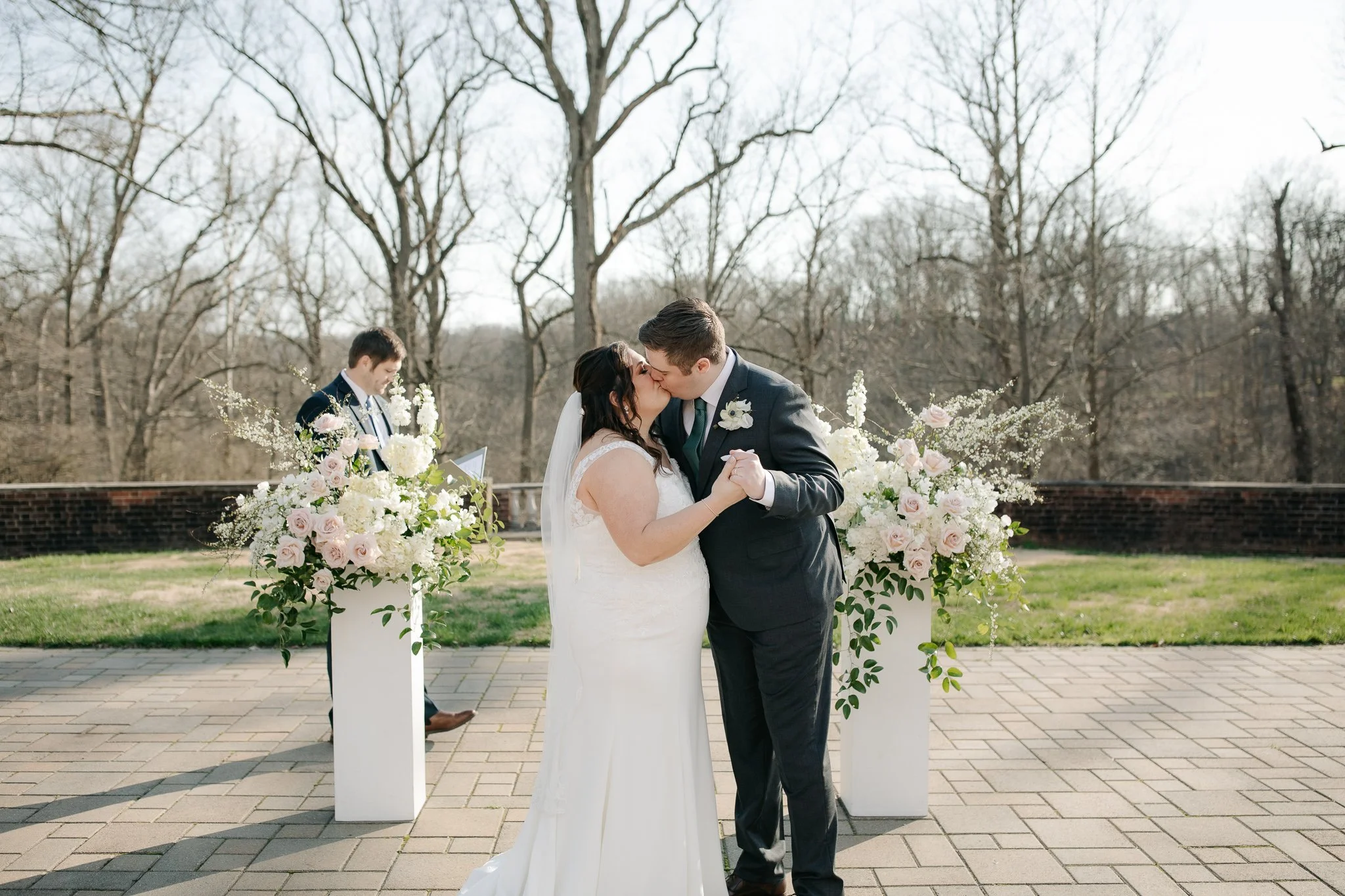Bride and groom sharing first kiss during terrace ceremony