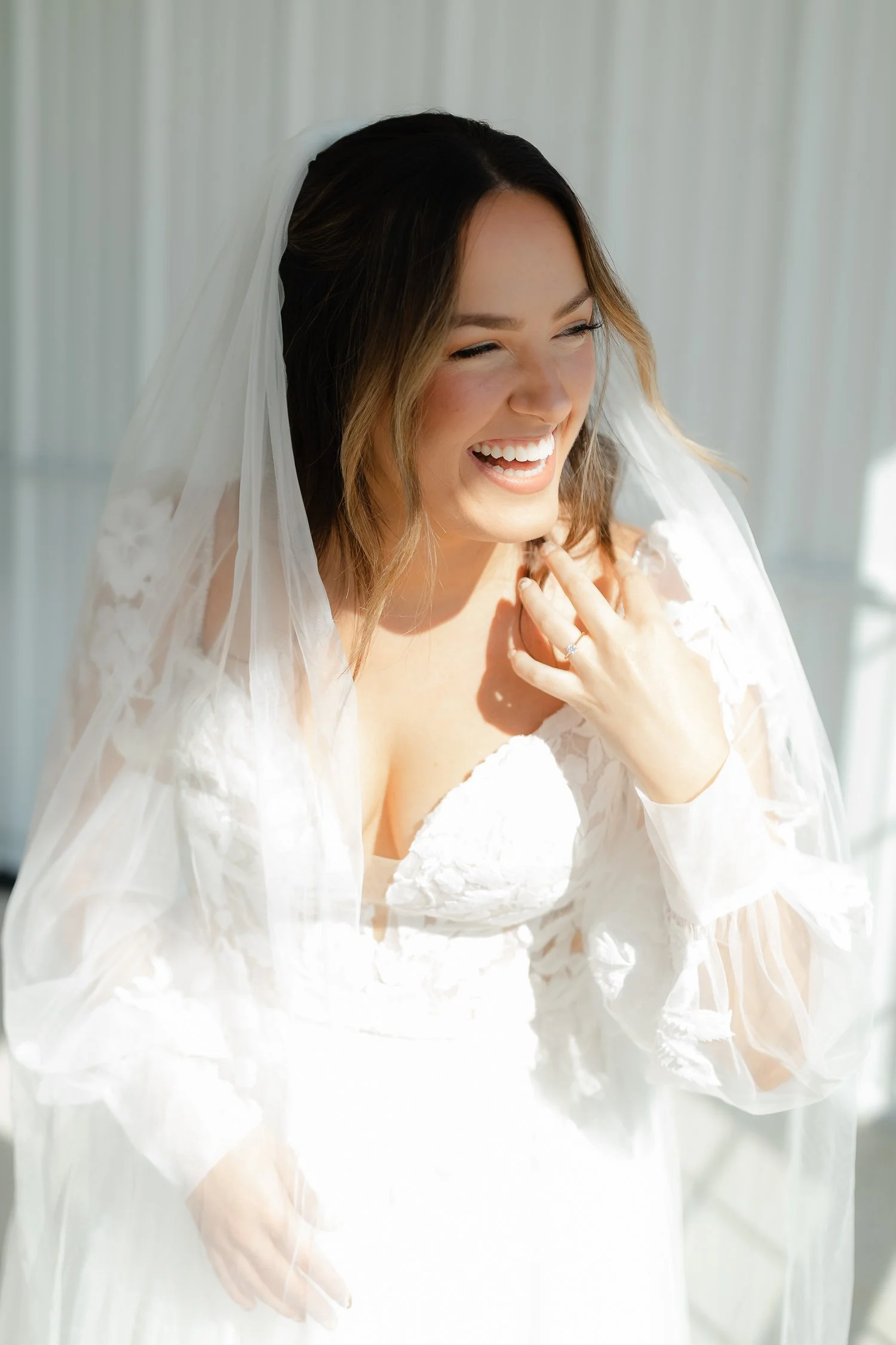 Candid portrait of the bride smiling in her veil during getting ready at Ivory Meadows in Yellow Springs, Ohio.